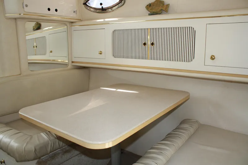 Slide: The Image of Interior cabin of 2000 Sea Ray 290 Sundancer with dining table and seating. - 11