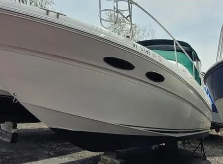 Slide: The Image of 2000 Sea Ray 290 Sundancer boat on dry dock, side view. - 3