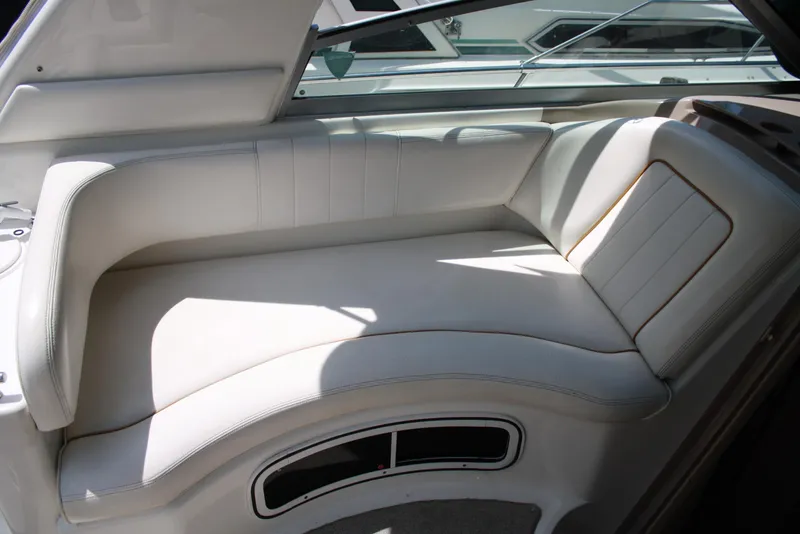 Slide: The Image of 2000 Sea Ray 290 Sundancer interior with white cushioned seating. - 6