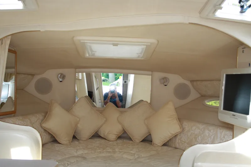 Slide: The Image of Interior of 2000 Sea Ray 290 Sundancer with cozy seating and pillows. - 7