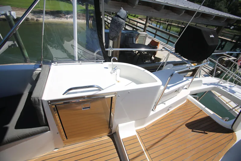 Slide: The Image of 2007 Beneteau Swift Trawler 42 deck with wood flooring and outdoor sink. - 12
