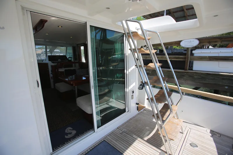 Slide: The Image of 2007 Beneteau Swift Trawler 42 interior view with ladder and sliding glass door. - 15