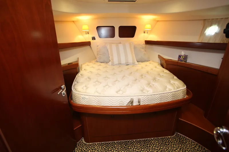 Slide: The Image of 2007 Beneteau Swift Trawler 42 cabin with cozy bed and warm lighting. - 20