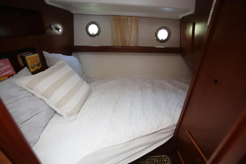 Slide: The Image of Cozy cabin interior of 2007 Beneteau Swift Trawler 42 with bed and portholes. - 21