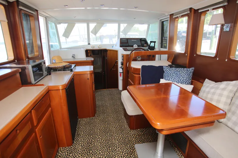Slide: The Image of Interior of 2007 Beneteau Swift Trawler 42 with wood finishes and seating area. - 23