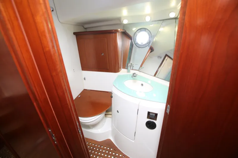 Slide: The Image of 2007 Beneteau Swift Trawler 42 bathroom with wooden cabinetry and modern fixtures. - 30