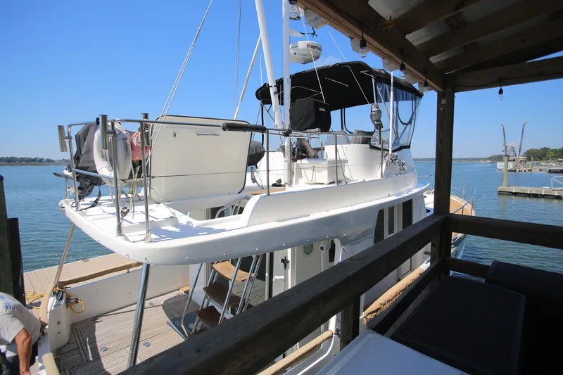 Slide: The Image of 2007 Beneteau Swift Trawler 42 docked, featuring upper deck and railing. - 4