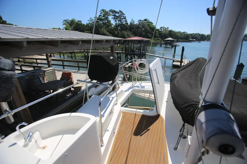 Slide: The Image of 2007 Beneteau Swift Trawler 42 docked, featuring spacious deck and scenic waterfront view. - 8