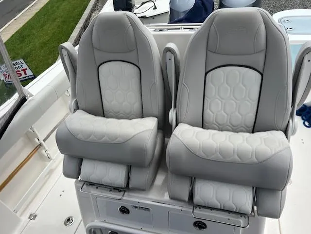 Slide: The Image of 2020 Sea Fox 288 Commander boat seats with gray upholstery and hexagonal pattern. - 5