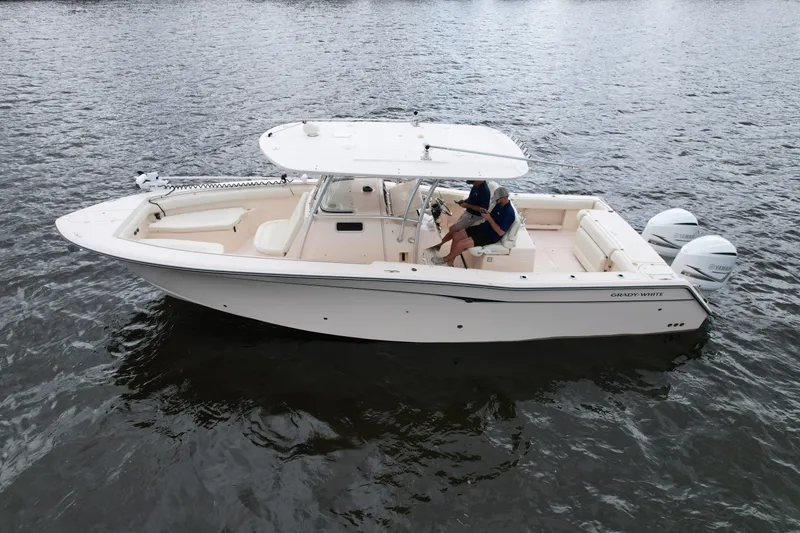 Slide: The Image of 2008 Grady-White Canyon 336 boat on water, featuring dual engines and spacious deck. - 11