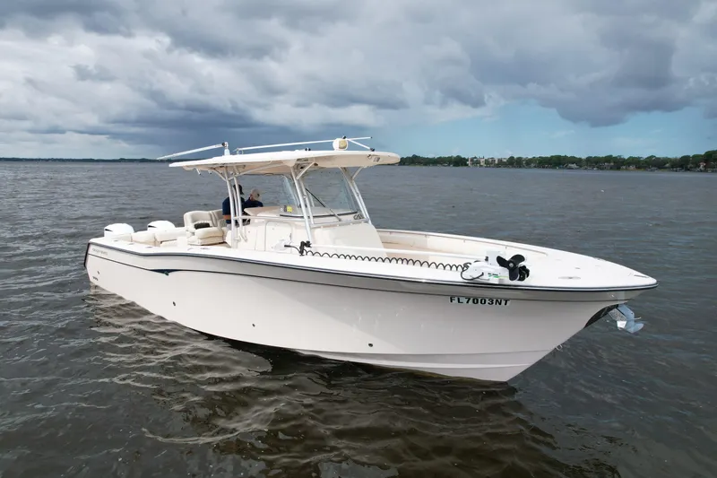 Slide: The Image of 2008 Grady-White Canyon 336 boat on calm water under cloudy sky. - 2