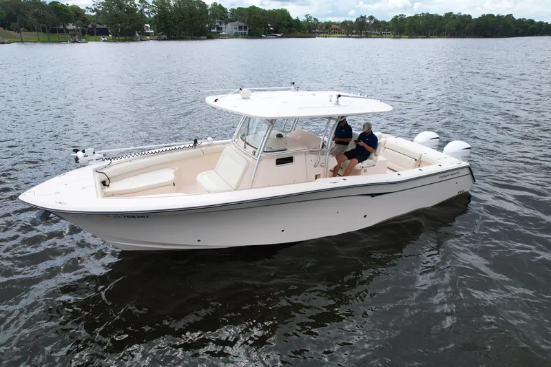 Slide: The Image of 2008 Grady-White Canyon 336 boat on calm water, featuring a spacious deck and twin engines. - 6