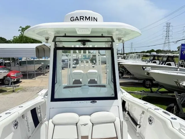 Slide: The Image of 2024 Tidewater 292 CC Adventure boat with Garmin equipment, docked at a marina. - 10
