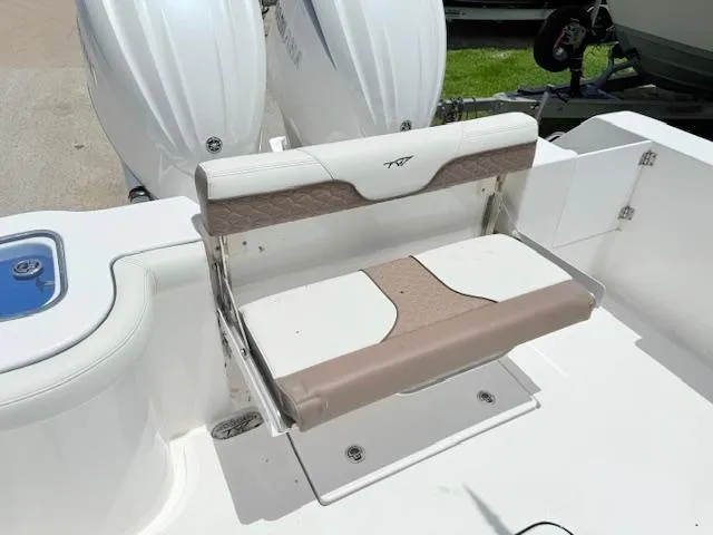 Slide: The Image of 2024 Tidewater 292 CC Adventure boat seat with dual engines in the background. - 3