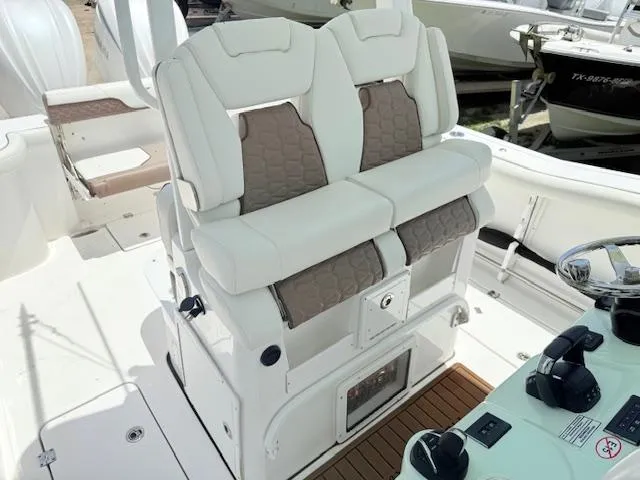Slide: The Image of 2024 Tidewater 292 CC Adventure boat seating and helm, featuring modern design and controls. - 7