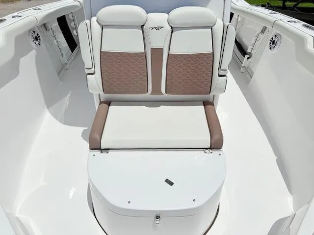 Slide: The Image of 2024 Tidewater 292 CC Adventure boat seating with white and brown upholstery. - 9