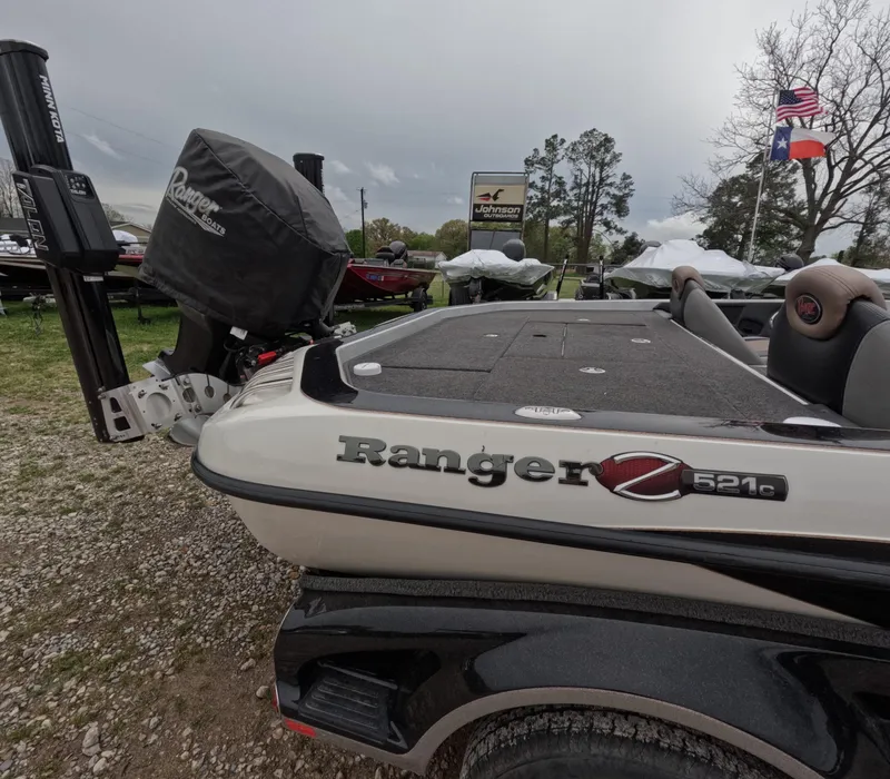 Slide: The Image of 2014 Ranger Z521C Comanche boat displayed outdoors with flags in the background. - 6