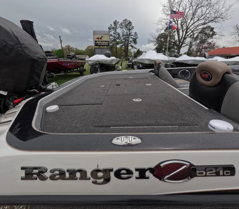 Slide: The Image of 2014 Ranger Z521C Comanche boat on display with American flag in background. - 8