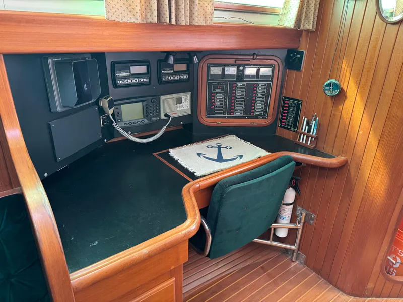 Slide: The Image of Navigation station on 1987 Hans Christian Christina 40 sailboat with control panels and equipment. - 10