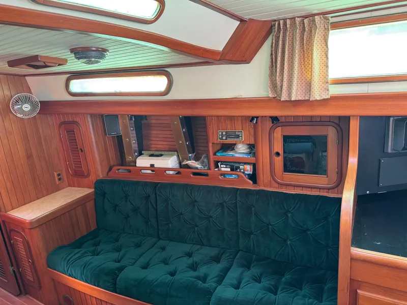Slide: The Image of Interior of 1987 Hans Christian Christina 40 sailboat with green cushioned seating. - 13