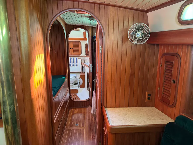 Slide: The Image of Interior of 1987 Hans Christian Christina 40 sailboat with wooden paneling and cozy cabin layout. - 14
