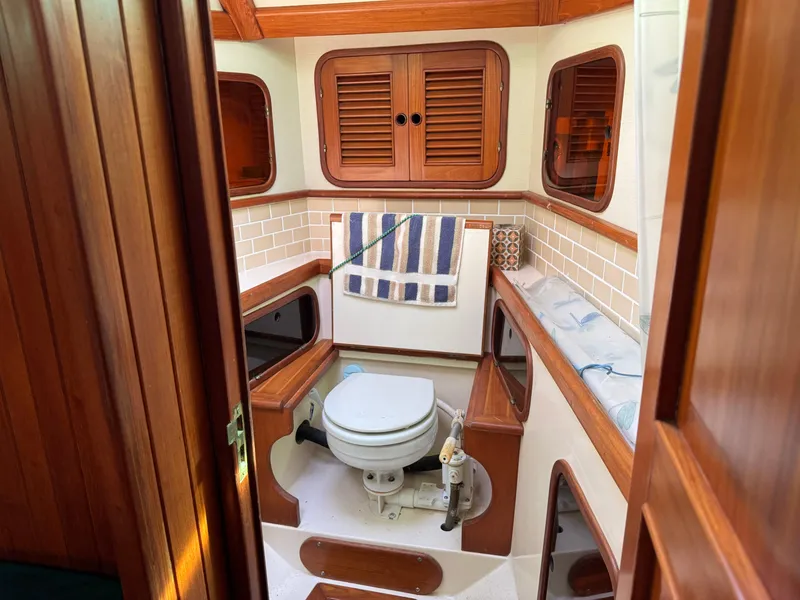 Slide: The Image of 1987 Hans Christian Christina 40 yacht bathroom with wooden accents and nautical decor. - 17