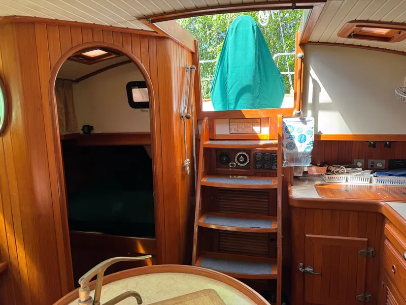 Slide: The Image of Interior of 1987 Hans Christian Christina 40 sailboat with wooden finish and compact kitchen. - 3
