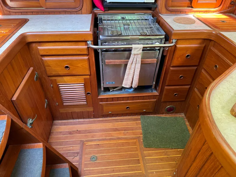 Slide: The Image of 1987 Hans Christian Christina 40 yacht kitchen with wooden cabinetry and stove. - 7