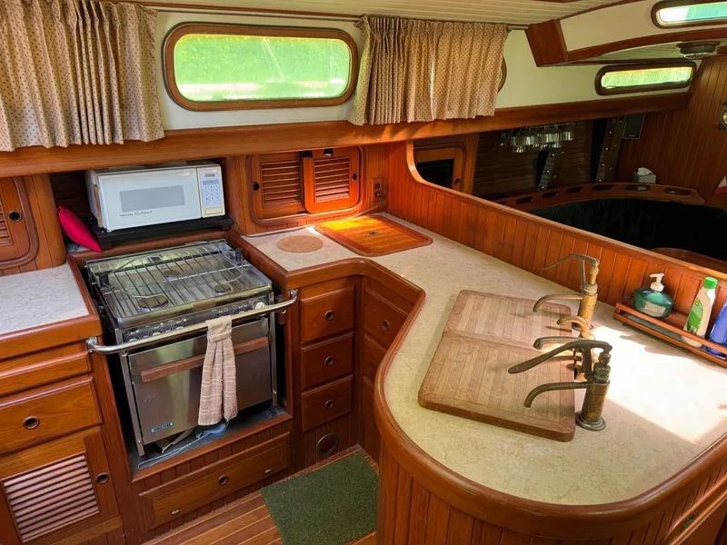 Slide: The Image of Cozy 1987 Hans Christian Christina 40 yacht kitchen with wood cabinetry and modern appliances. - 8