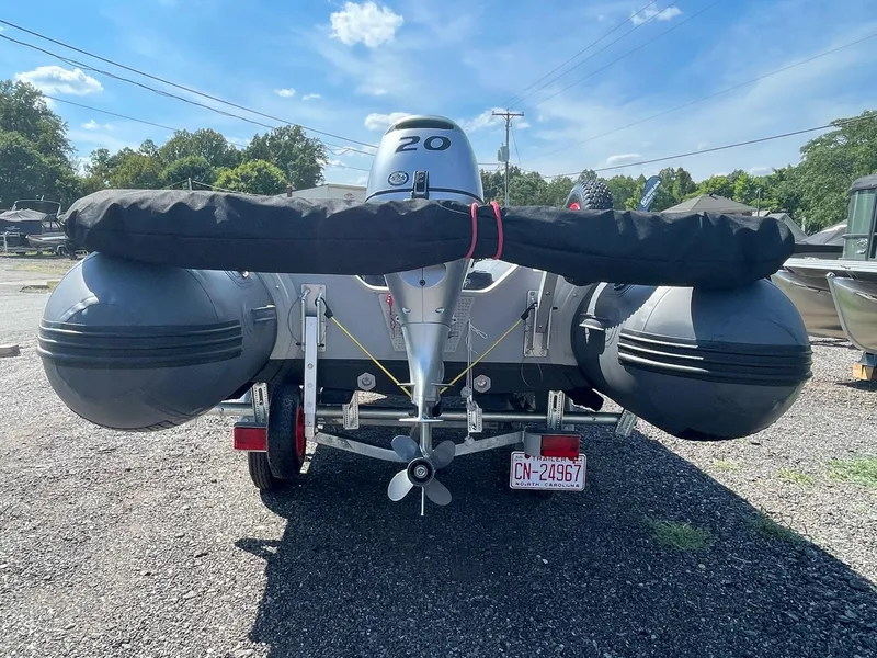 Slide: The Image of 2021 Saturn HD430 inflatable boat on trailer, rear view with motor, outdoors. - 5