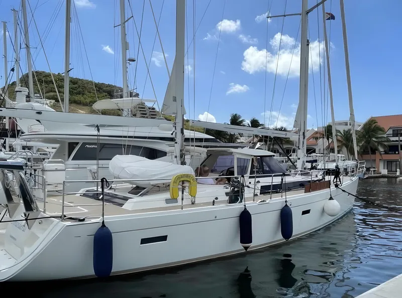 The Image of Sailing yacht Amel 55, 2012 model, docked in a marina under a clear blue sky. - 0