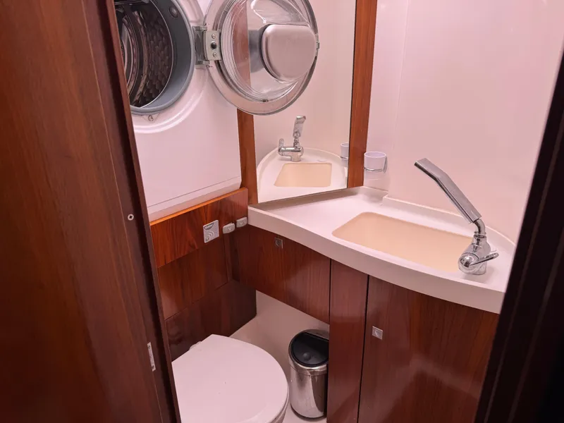 Slide: The Image of Compact bathroom in 2012 Amel 55 yacht with wooden cabinetry and modern fixtures. - 18