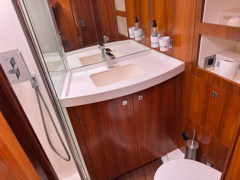 Slide: The Image of Luxurious bathroom in 2012 Amel 55 yacht with wood finish and modern fixtures. - 19