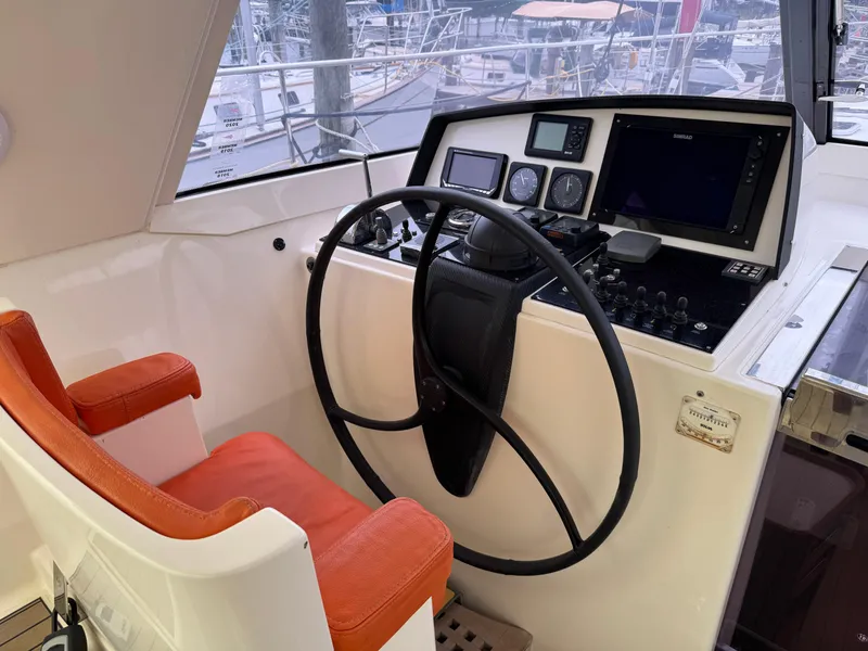 Slide: The Image of Helm of 2012 Amel 55 yacht with orange seat and navigation instruments. - 2