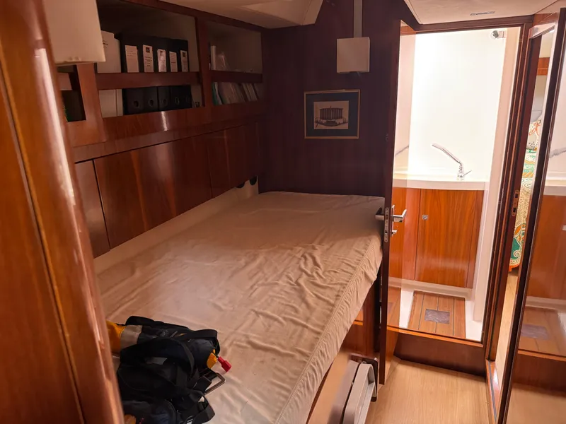 Slide: The Image of Cozy cabin interior of 2012 Amel 55 yacht with bed and wooden furnishings. - 20