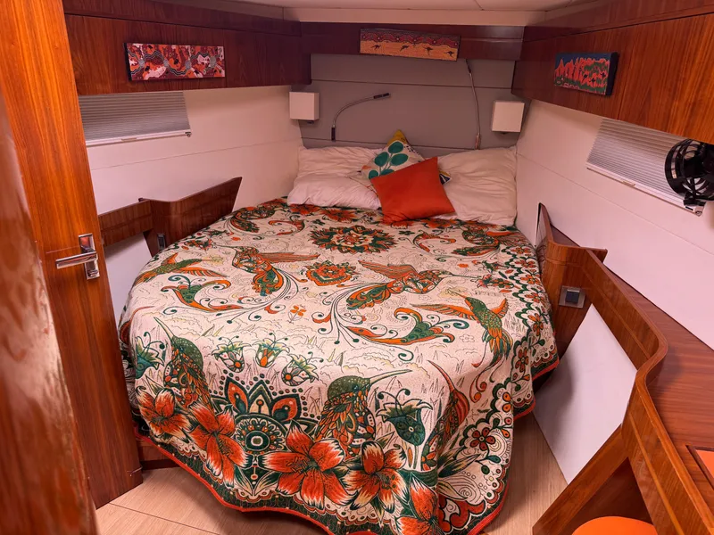 Slide: The Image of Cozy cabin interior of 2012 Amel 55 yacht with vibrant floral bedspread. - 21