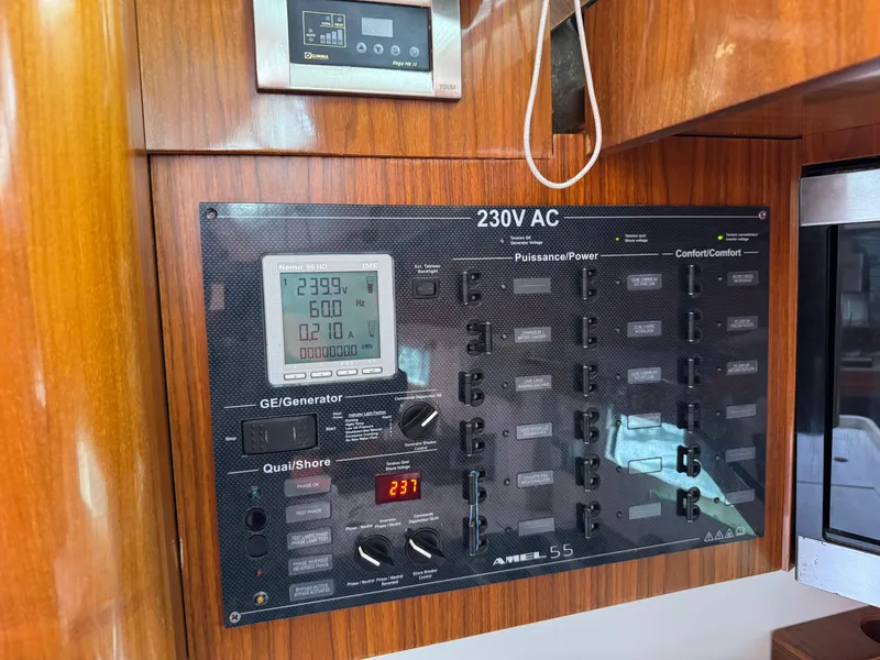 Slide: The Image of Electrical control panel on a 2012 Amel 55 yacht, featuring 230V AC system. - 23