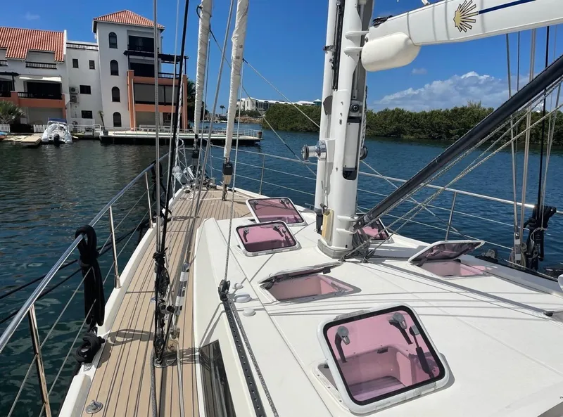 Slide: The Image of Sailing yacht Amel 55, 2012 model, docked near waterfront buildings. - 24