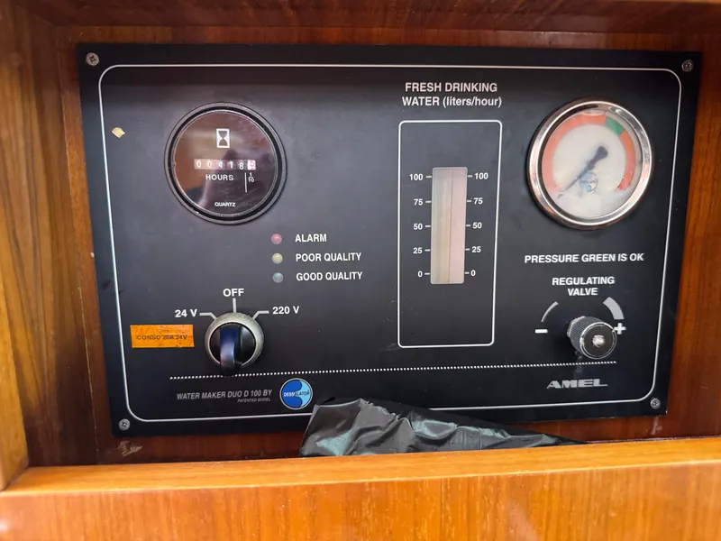Slide: The Image of Control panel of Amel 55 water maker, 2012 model, showing water quality and pressure gauges. - 25