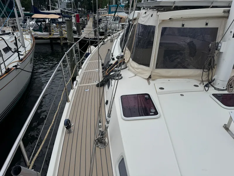Slide: The Image of Sailboat deck view of 2012 Amel 55, docked at marina with other boats. - 29