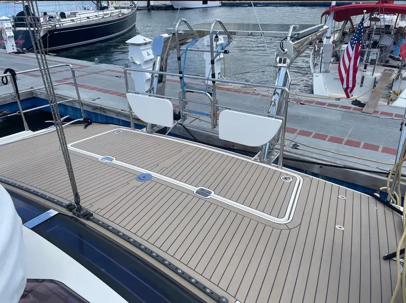 Slide: The Image of Deck of 2012 Amel 55 yacht docked at marina with American flag. - 33
