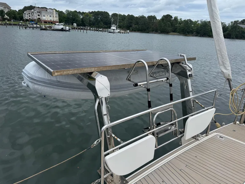 Slide: The Image of Sailboat Amel 55 (2012) with solar panel and dinghy on a calm lake. - 34