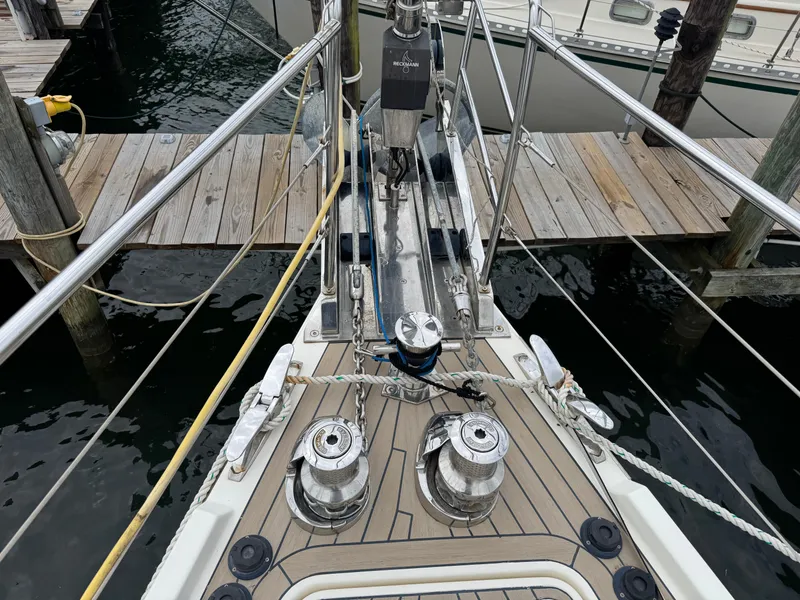 Slide: The Image of Bow of 2012 Amel 55 yacht docked, featuring winches and deck fittings. - 35