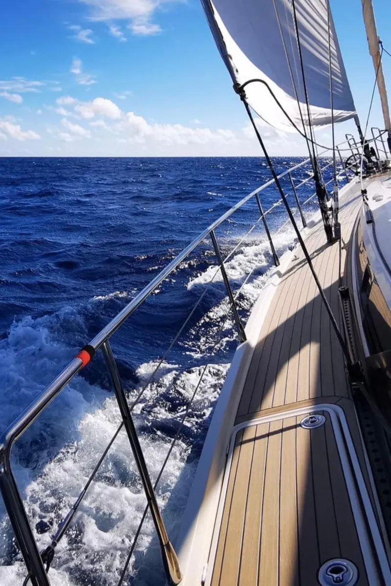 Slide: The Image of Sailing on a 2012 Amel 55 yacht, ocean view, clear skies, and vibrant blue waters. - 38
