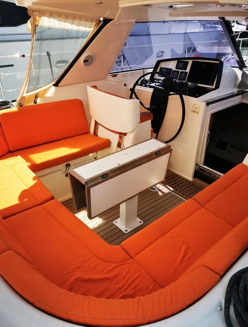 Slide: The Image of Interior of 2012 Amel 55 yacht with orange seating and modern helm. - 6