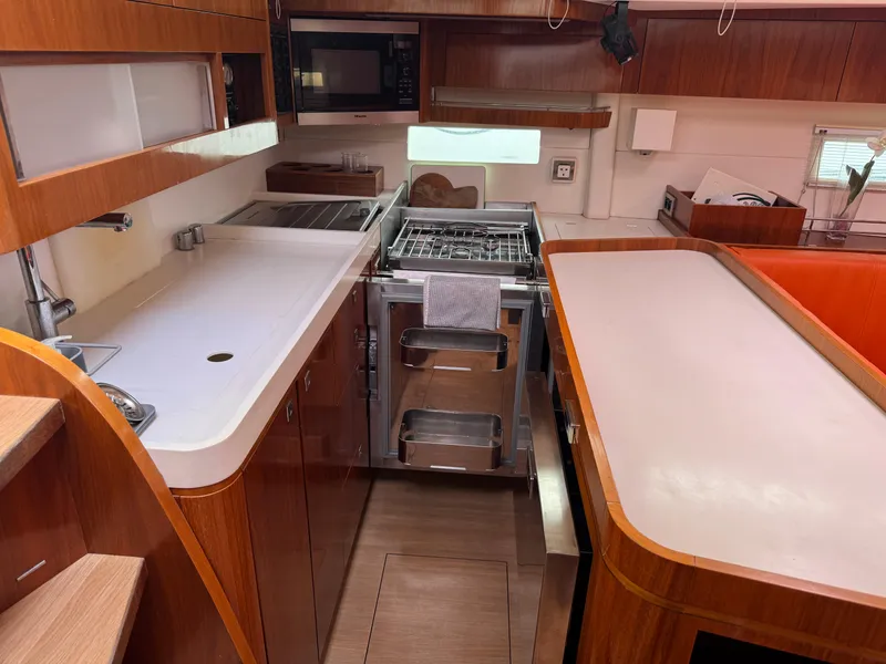 Slide: The Image of Modern kitchen interior of 2012 Amel 55 yacht with wooden cabinetry and stainless steel appliances. - 7