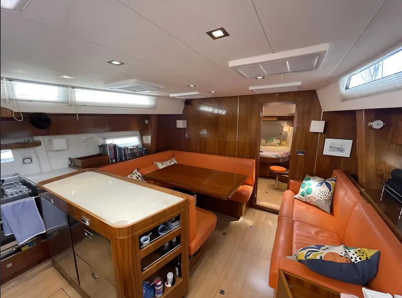 Slide: The Image of Luxurious interior of a 2012 Amel 55 yacht with orange seating and wooden finishes. - 8