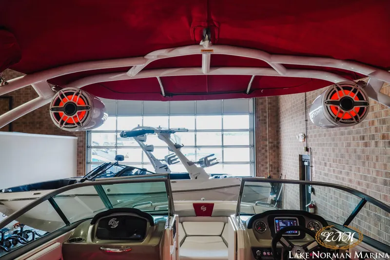 Slide: The Image of 2018 Chaparral 21 Surf boat interior with red canopy and speakers at Lake Norman Marina. - 11