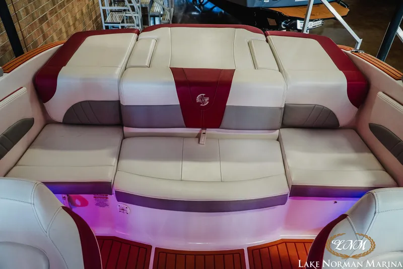 Slide: The Image of 2018 Chaparral 21 Surf boat interior with cushioned seating and ambient lighting. - 19
