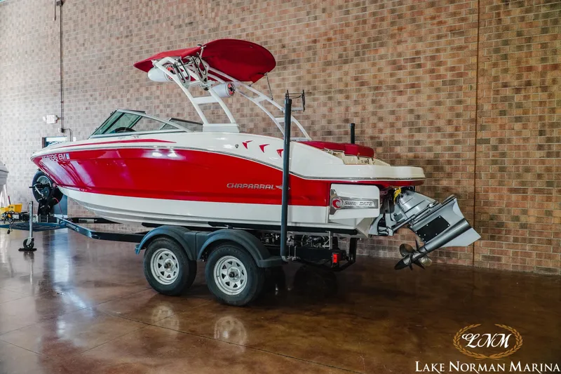 Slide: The Image of 2018 Chaparral 21 Surf boat in red and white on trailer at Lake Norman Marina. - 3